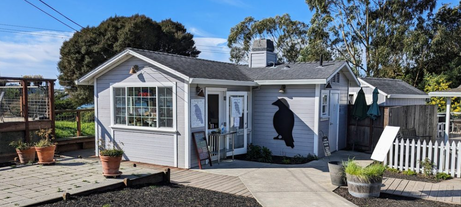 The Birds Cafe exterior — white building with raven silhouette
